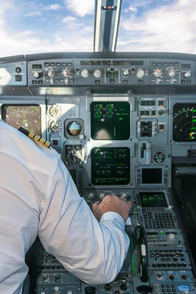 Pilot in the cockpit pulling the aircraft throttle