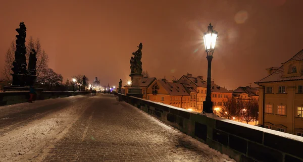 Night romantic snowy Prague Old Town above River Vltava, Czech republic