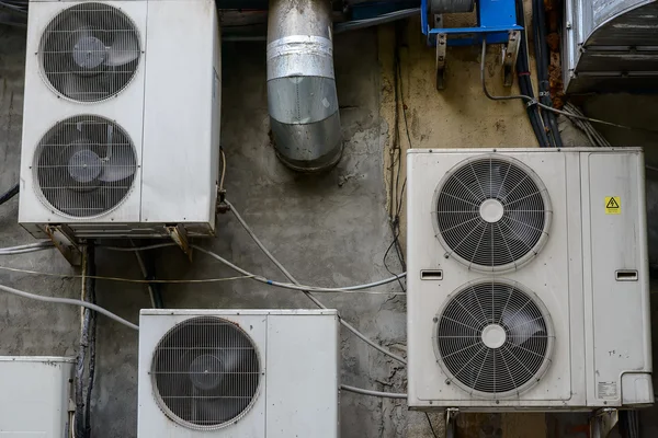 Group of air conditioner units outside building