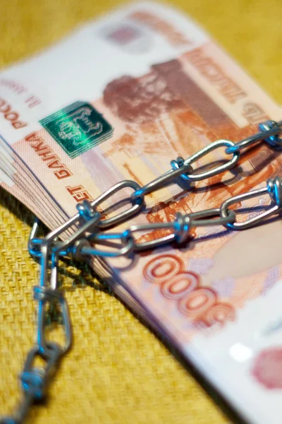 Russian money wrapped in a chain