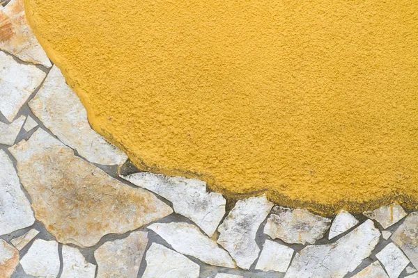 Yellow wall with stone