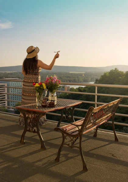 Woman on Balcony in Sunset