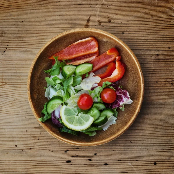 Fresh veggies salad on the wood