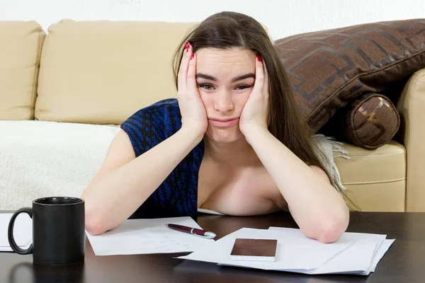 Stressed caucasian woman student learning from notes.