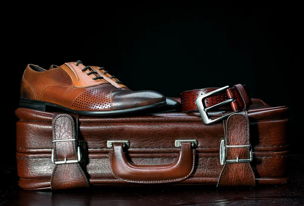 Men's leather shoes and a suitcase