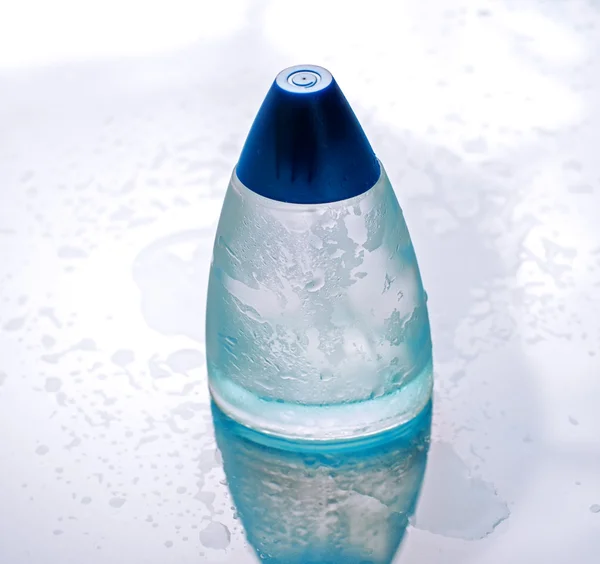 Blue perfume bottle on water