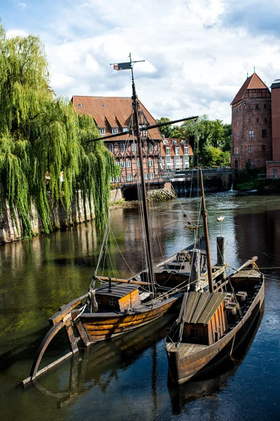 Wooden boats on river with houses