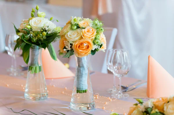 Flower bouquets on wedding dining table