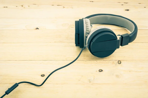 Black Headphones on wood desk.