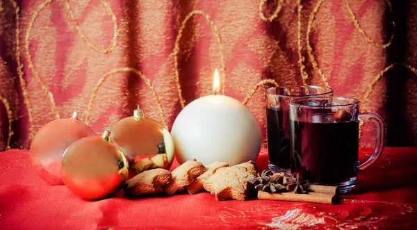 Round candle, balls, cookies, mulled wine and spices