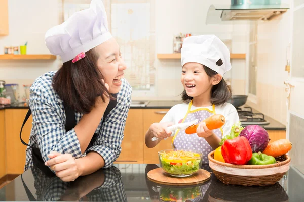 Asian mother teaching daughter making salad in kitchen,Cooking  Cooking  concept of happy asian little girl and mother making salad