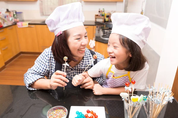 Mother and daughter making jelly candy in ktichen