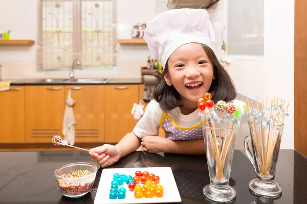 Little girl chef enjoy making jelly candy in kitchen