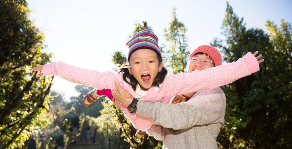 Father playing with daughter in day time. Concept of warm family