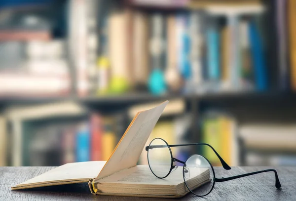 Glasses and book on table