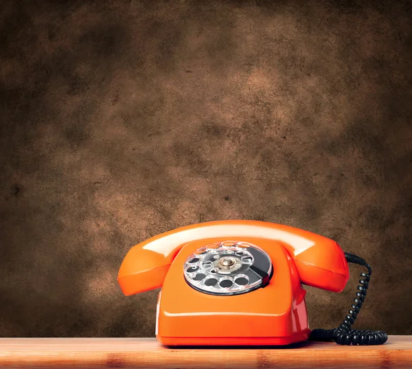 Vintage phone on brown background