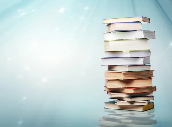 Stack of books isolated on blue