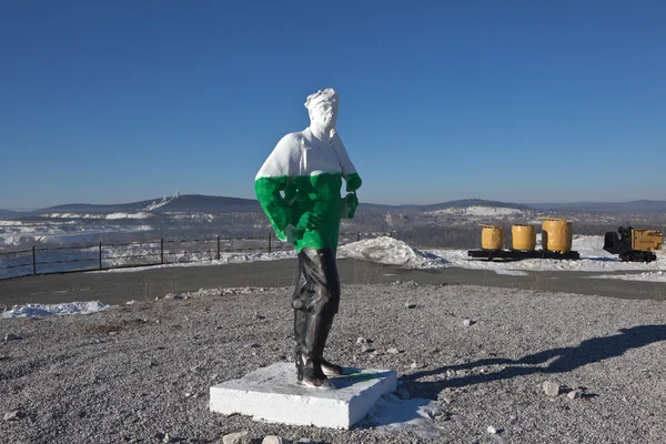 NIZHNY TAGIL, RUSSIA - MARCH 3, 2015: Photo of Sculpture miner on a mountaintop high.