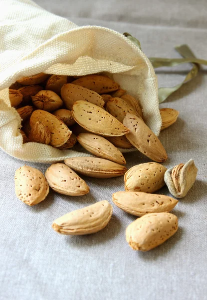 Almonds, lying in a small pouch.