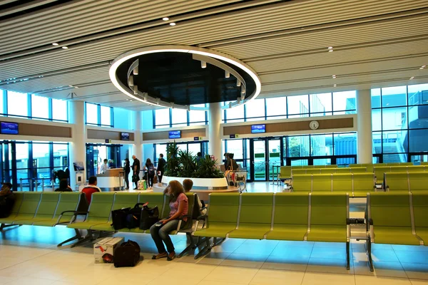 passengers waiting for their flight in the waiting room.