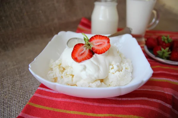 Dish of cottage cheese with sour cream and strawberries