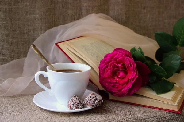 Rose, a cup of coffee and book