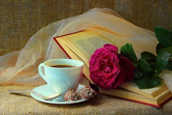 Rose, a cup of coffee and book