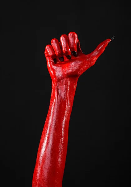 Red Devil's hands, red hands of Satan, Halloween theme, black background, isolated