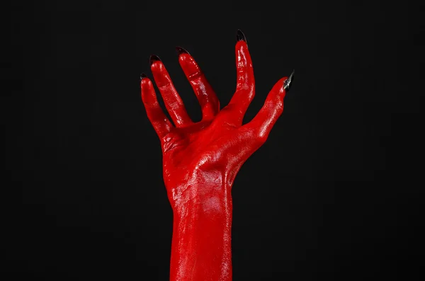 Red Devil's hands, red hands of Satan, Halloween theme, black background, isolated