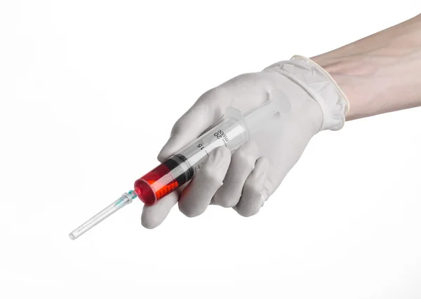 Doctor's hand holding a syringe, white-gloved hand, a large syringe, medical issue, the doctor makes an injection, white background, isolated, white gloves doctor, ebola test, red medication