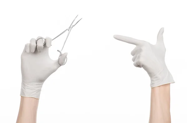 Surgery and Medical theme: doctor\'s hand in a white glove holding a surgical clip isolated on white background
