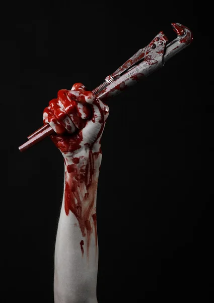 Bloody hand holding an adjustable wrench, bloody key, crazy plumber, bloody theme, halloween theme, black background,isolated , bloody hand of an assassin, bloody murderer, psycho,bloody monkey wrench