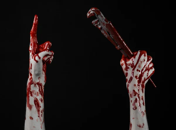 Bloody hand holding an adjustable wrench, bloody key, crazy plumber, bloody theme, halloween theme, black background,isolated , bloody hand of an assassin, bloody murderer, psycho,bloody monkey wrench