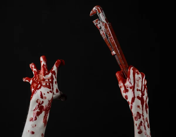 Bloody hand holding an adjustable wrench, bloody key, crazy plumber, bloody theme, halloween theme, black background,isolated , bloody hand of an assassin, bloody murderer, psycho,bloody monkey wrench