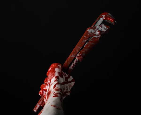 Bloody hand holding an adjustable wrench, bloody key, crazy plumber, bloody theme, halloween theme, black background,isolated , bloody hand of an assassin, bloody murderer, psycho,bloody monkey wrench