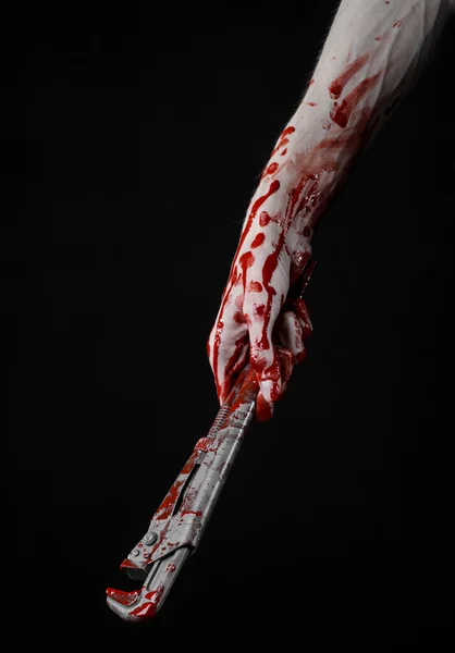 Bloody hand holding an adjustable wrench, bloody key, crazy plumber, bloody theme, halloween theme, black background,isolated , bloody hand of an assassin, bloody murderer, psycho,bloody monkey wrench