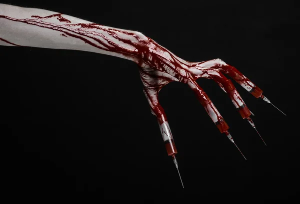 Bloody hand with syringe on the fingers, toes syringes, hand syringes, horrible bloody hand, halloween theme, zombie doctor, black background, isolated