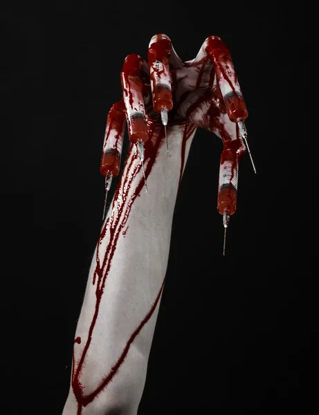 Bloody hand with syringe on the fingers, toes syringes, hand syringes, horrible bloody hand, halloween theme, zombie doctor, black background, isolated