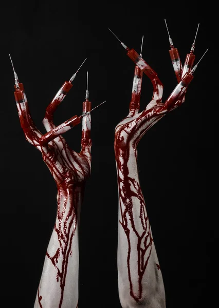 Bloody hand with syringe on the fingers, toes syringes, hand syringes, horrible bloody hand, halloween theme, zombie doctor, black background, isolated