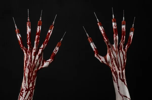 Bloody hand with syringe on the fingers, toes syringes, hand syringes, horrible bloody hand, halloween theme, zombie doctor, black background, isolated