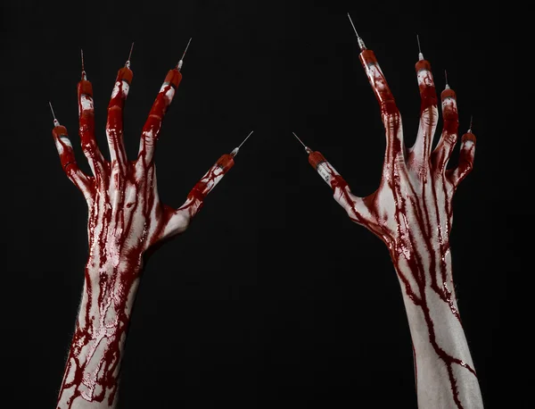 Bloody hand with syringe on the fingers, toes syringes, hand syringes, horrible bloody hand, halloween theme, zombie doctor, black background, isolated