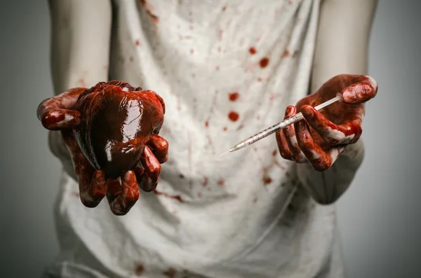 Social advertising and the fight against drug addiction: bloody hands addict holding syringe and bloody human heart