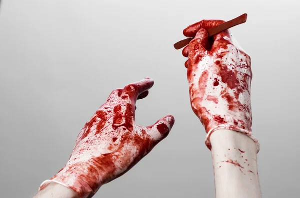 Bloody hands in gloves with the scalpel, white background, isolated, doctor, killer, maniac