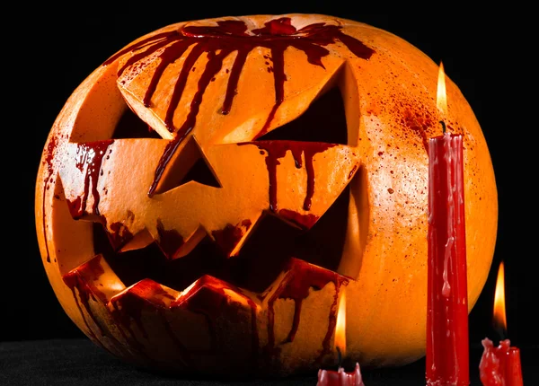 Bloody pumpkin, jack lantern, pumpkin halloween, red candles on a black background, halloween theme, pumpkin killer
