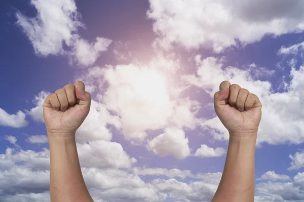 Success concept, male hand rise up  on blue sky background with