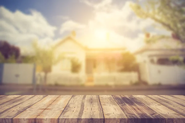 Wood table top (as house) on blur house background - can be used