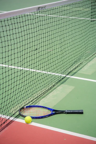 Tennis racket and balls on the tennis court