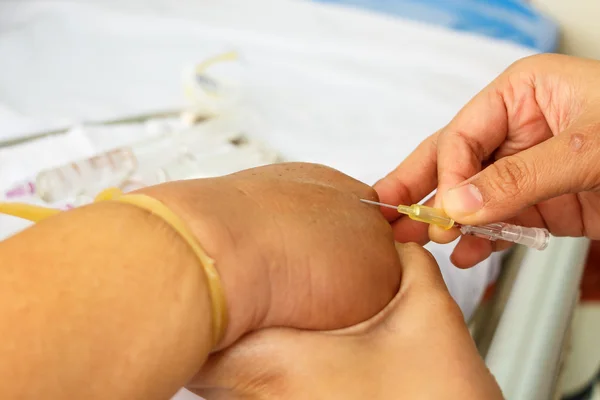 Asian nurse inject at patient's hand for intraveneous fluid