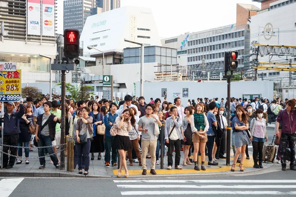 Tokyo ,Japan - May 25 ,2014. Many people cross the street and tr