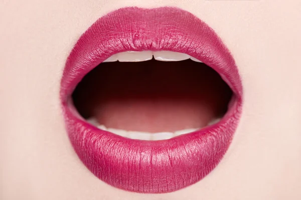 Close-up of open mouth woman with beautiful red lips